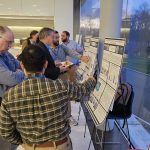 Picture of Francis Vasquez presenting poster at the connecticut power electronics symposium