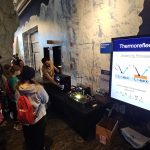 Alejandro teaching high school students how to perform thermoreflectance imaging